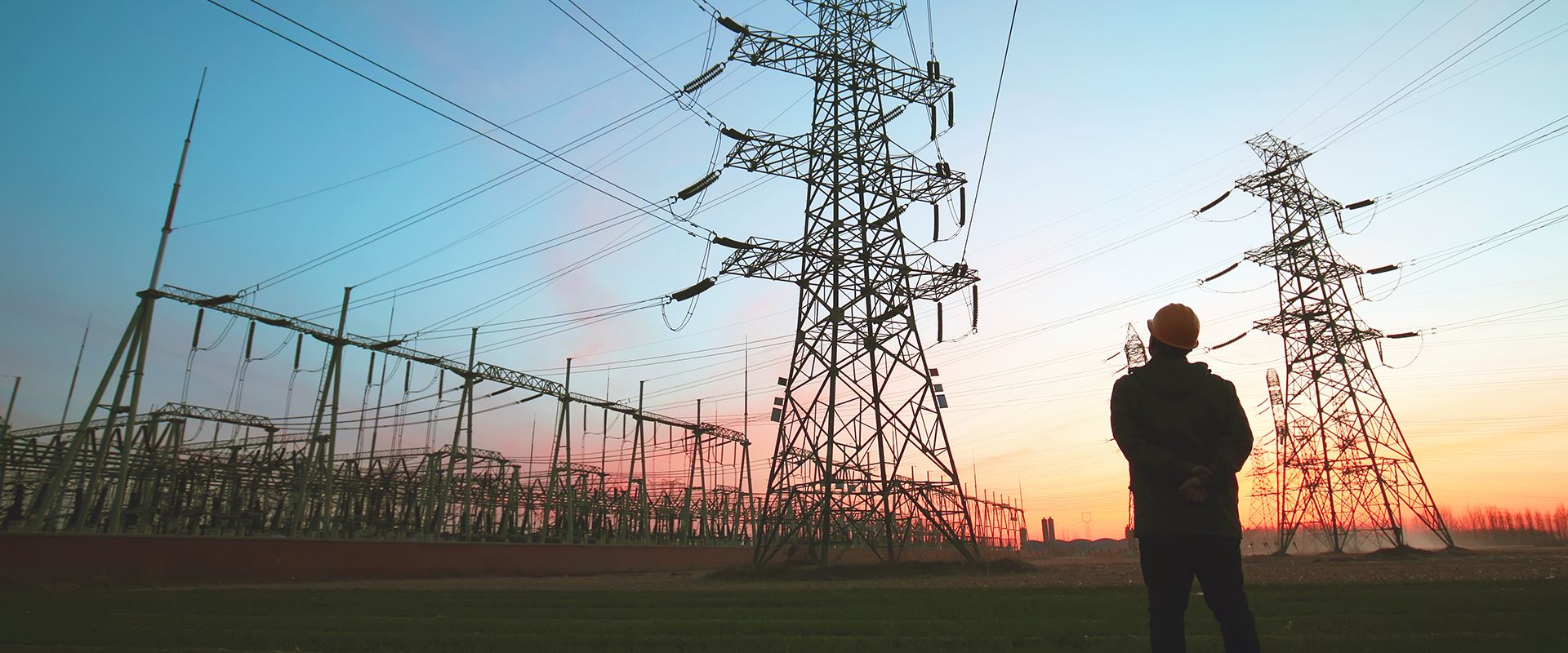 man standing next to power lines