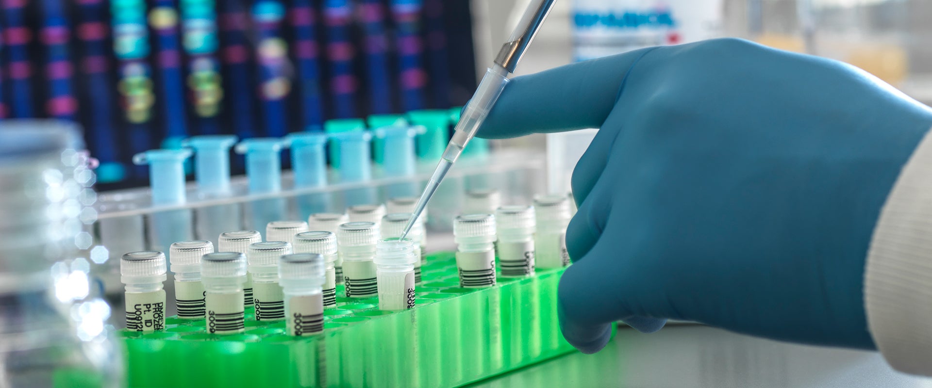 lab worker pipetting into vials