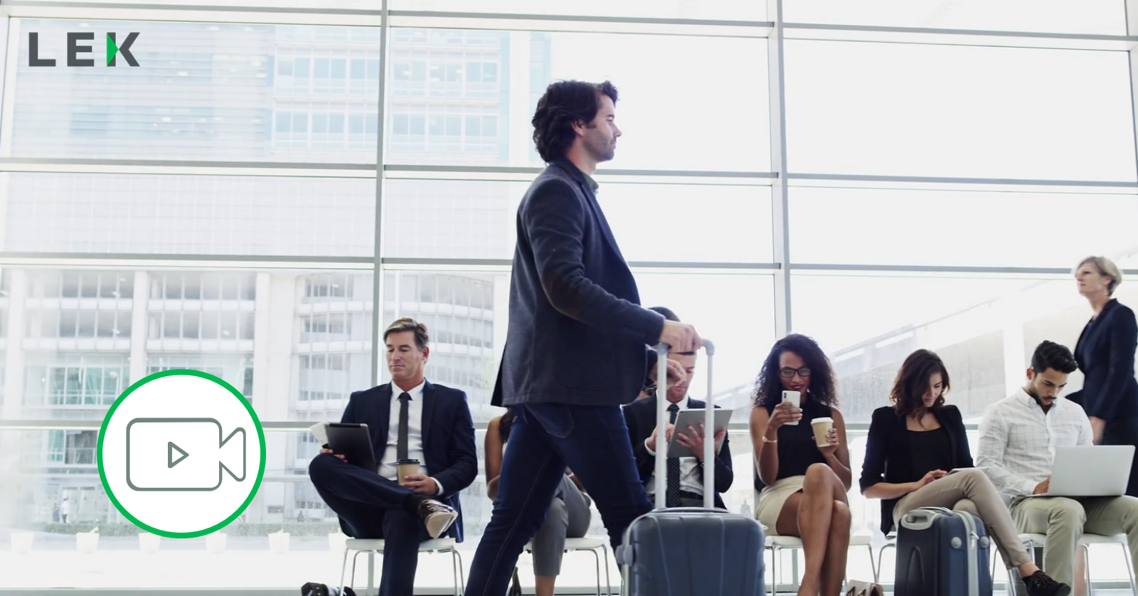 man walking with suitcase through airport