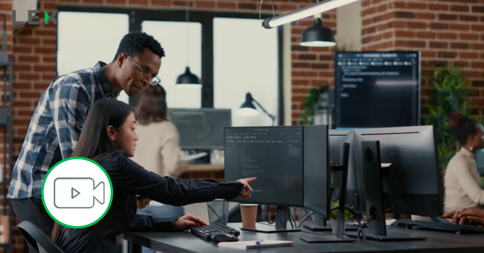 coworkers coding on monitors